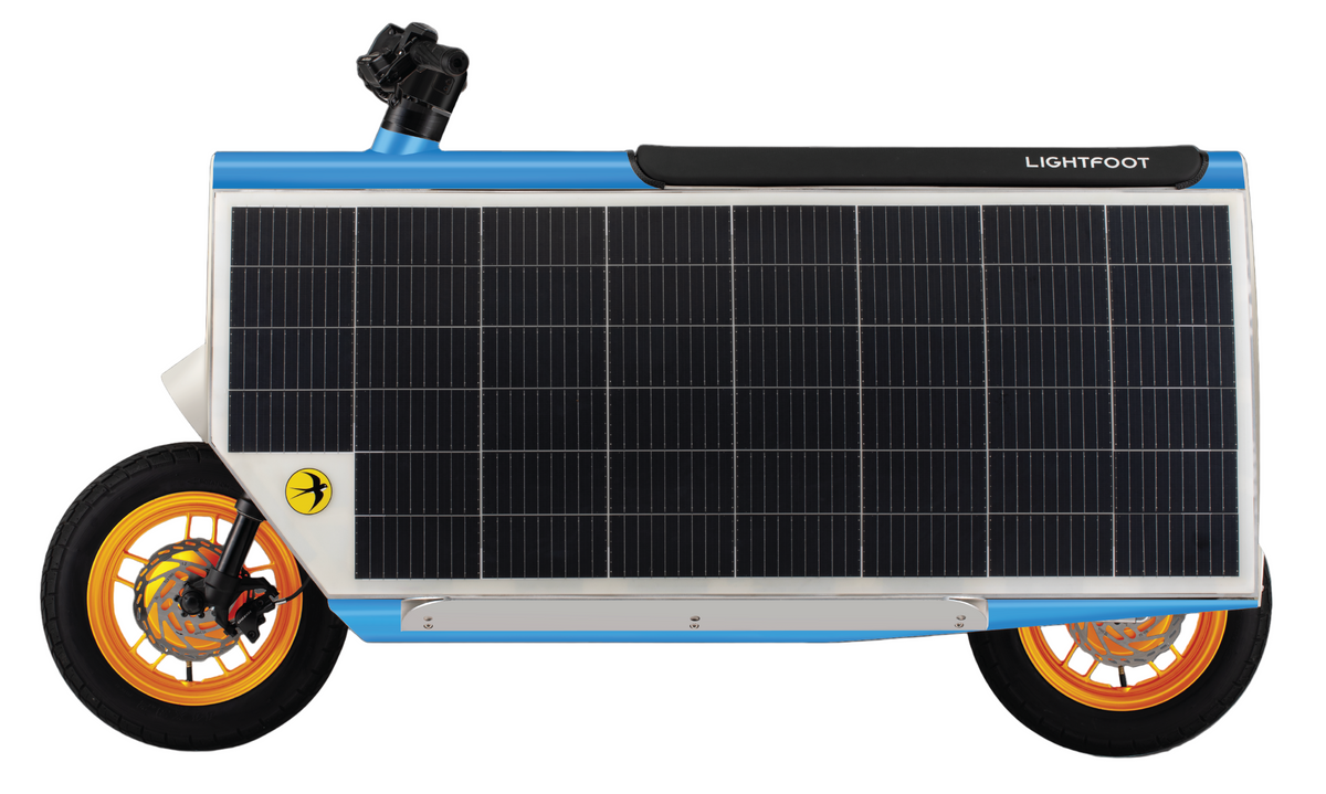 A micromobility vehicle with a large solar panel on the side, featuring orange wheels and a black and white body.