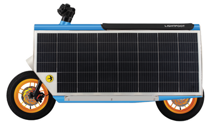 A micromobility vehicle with a large solar panel on the side, featuring orange wheels and a black and white body.